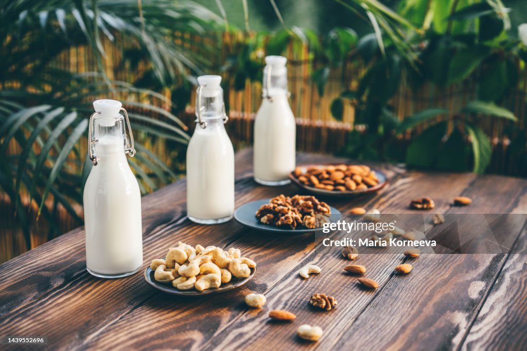 Glass bottles of various vegan milks.