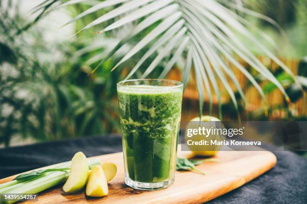 green smoothie at the bottle. - avocado smoothie stock pictures, royalty-free photos & images