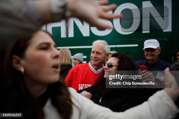 Sen. Ron Johnson poses for photographs with supporters next to his bus during a campaign rally on November 06, 2022 in Madison, Wisconsin. Johnson is...