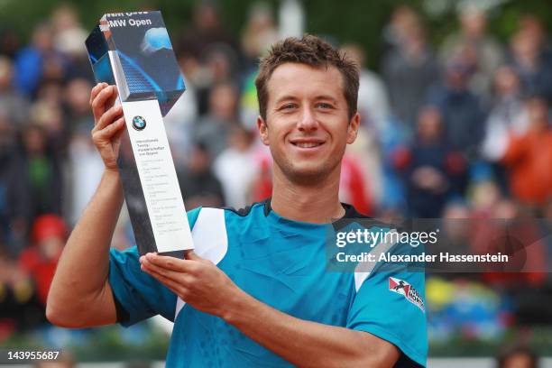 Philipp Kohlschreiber of Germany poses with the winners trophy after winning his final match against Marino Cilic of Croatia at BMW Open at Iphitos...