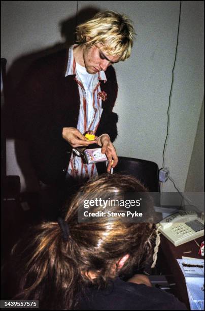 Nirvana rock group guitarist/singer Kurt Cobain signs autographs for fans backstage Belfast UK 1992.