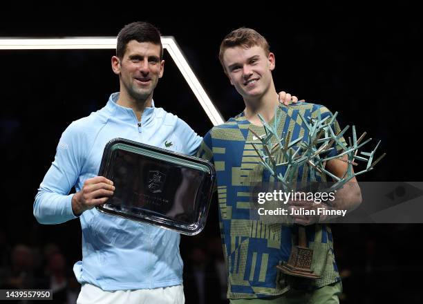 Holger Rune or Denmark celebrates with the winners trophy next to runner up Novak Djokovic of Serbia after the final during Day Seven of the Rolex...