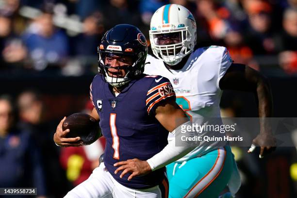 Justin Fields of the Chicago Bears runs the ball for a first down during the first half in the game against the Miami Dolphins at Soldier Field on...