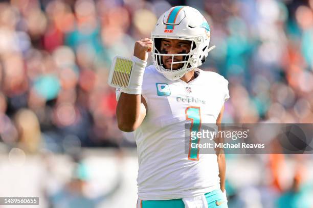 Tua Tagovailoa of the Miami Dolphins celebrates a touchdown during the first half in the game against the Chicago Bears at Soldier Field on November...