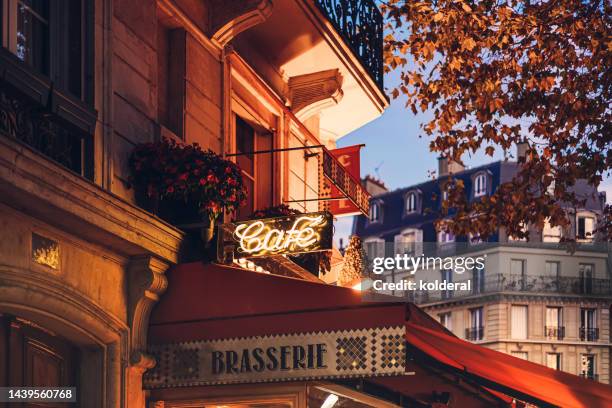 parisian cafe at twilight - paris stock pictures, royalty-free photos & images