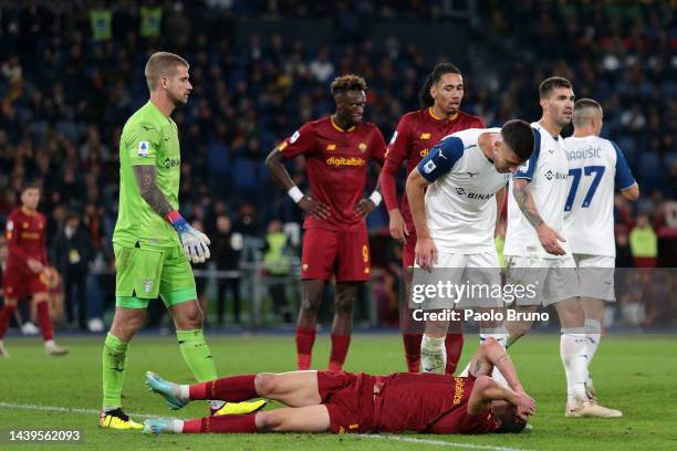 Andrea Belotti of AS Roma holds their head as they are confronted by Nicolo Casale of SS Lazio during the Serie A match between AS Roma and SS Lazio...