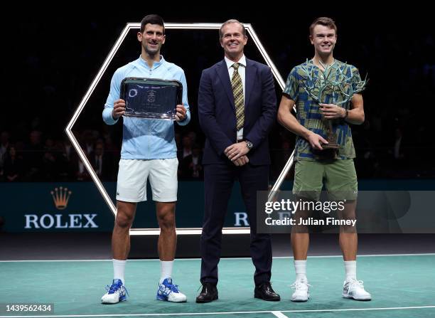 Stefan Edberg stands with Holger Rune or Denmark the winner and the runner up Novak Djokovic of Serbia after the final during Day Seven of the Rolex...