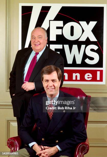 Television executive and Chairman of Fox News Roger Ailes with Brit Hume in front of logo of recently launched Fox News Channel at Television Critics...