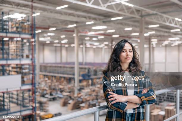 portrait of a young woman working in a distribution warehouse - skogshuggarskjorta bildbanksfoton och bilder