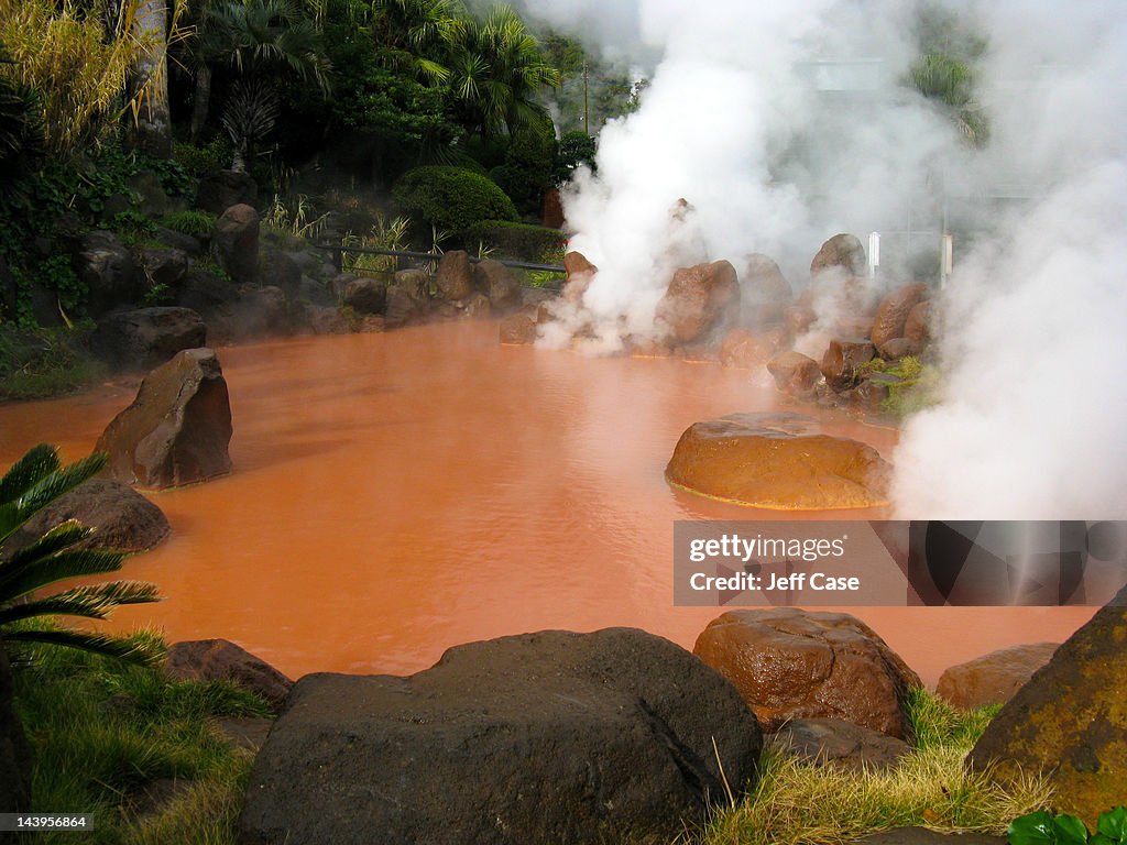 Red pool of steaming water