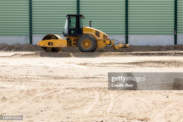 road construction site with road roller - pressmaschine stock-fotos und bilder