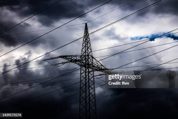 electricity pylon with dramatic sky - blackout stock pictures, royalty-free photos & images