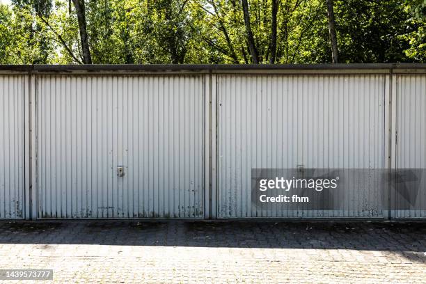 two white dirty garage doors - garagentor stock-fotos und bilder