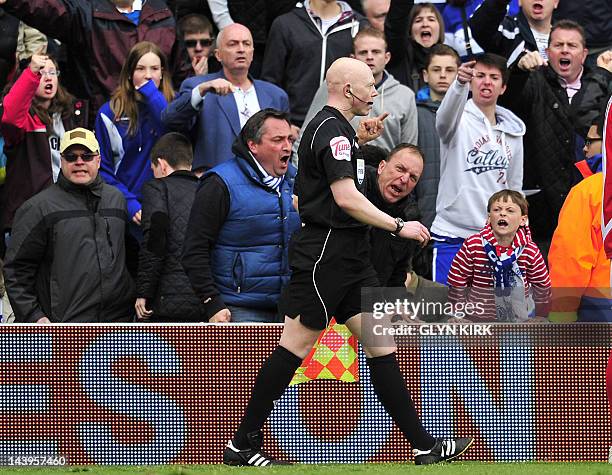 The assistant referee receives abuse from the Queens Park Rangers' fans during the English Premier League football match between Queens Park Rangers...