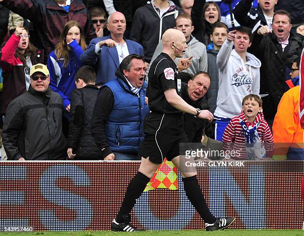 The assistant referee receives abuse from the Queens Park Rangers' fans during the English Premier League football match between Queens Park Rangers...