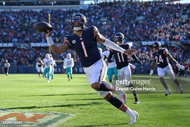 Justin Fields of the Chicago Bears scores a touchdown during the second half in the game against the Miami Dolphins at Soldier Field on November 06,...