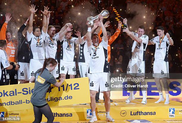Marcus Ahlm of THW Kiel celebrates with the trophy after winning the Lufthansa Final 4 match between THW Kiel and SG Flensburg - Handewitt at the O2...