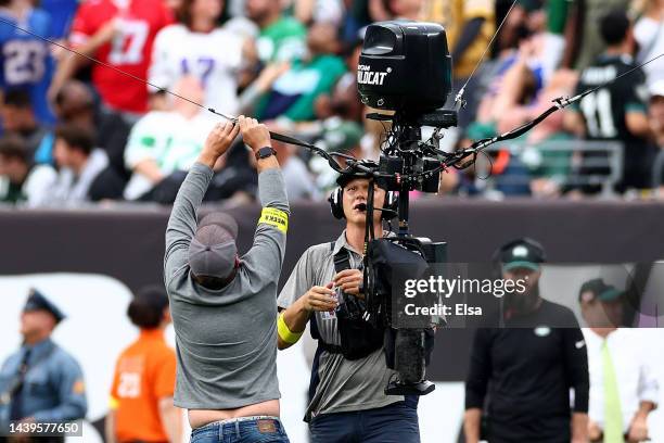 Crews work to repair a Skycam that broke in the second half of a game between the Buffalo Bills and the New York Jets at MetLife Stadium on November...