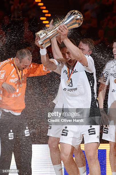 Marcus Ahlm of THW Kiel celebrates with the trophy after winning the Lufthansa Final 4 match between THW Kiel and SG Flensburg - Handewitt at the O2...