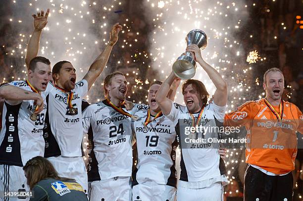 Dominik Klein, Daniel Narcisse, Aron Palmarsson,Tobias Reichmann and Christian Sprenger of THW Kiel celebrate with the trophy after winning the...