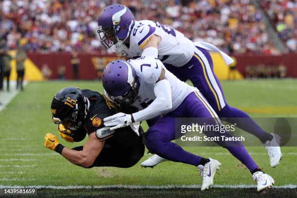 Dax Milne of the Washington Commanders catches a pass for a touchdown during the fourth quarter of the game against the Minnesota Vikings at...