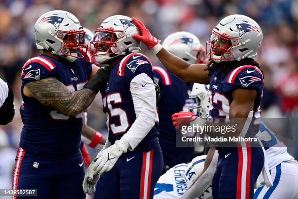Josh Uche of the New England Patriots celebrates with teammates after making a tackle against the Indianapolis Colts during the third quarter at...