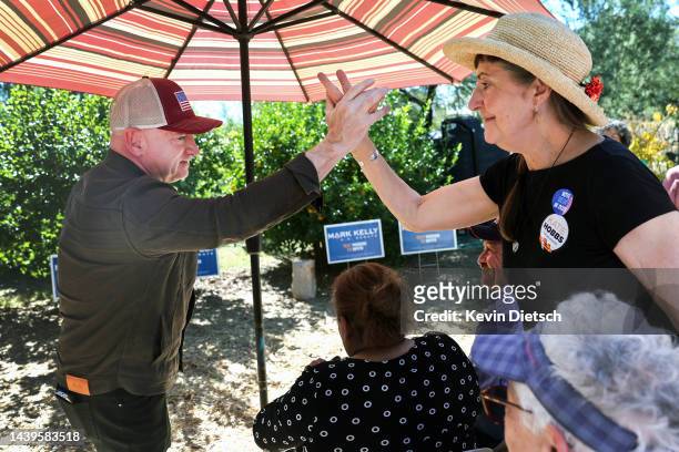 Sen. Mark Kelly greets volunteers at a backyard rally on November 06, 2022 in Tucson, Arizona. With two days to go before election day, current...