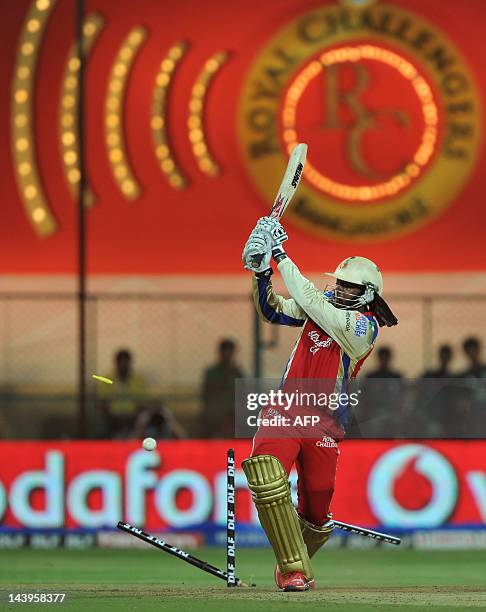 Royal Challengers Bangalore batsman Chris Gayle is bowled out by Deccan Chargers bowler Anand Rajan during the IPL Twenty20 cricket match between...