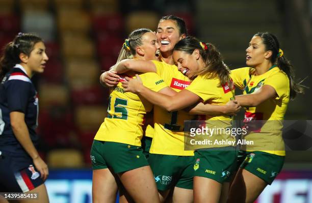 Olivia Kernick of Australia celebrates their sides thirteenth try with team mates Tarryn Aiken during the Women's Rugby League World Cup Group B...