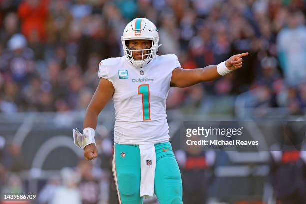 Tua Tagovailoa of the Miami Dolphins signals for a first down during the fourth quarter in the game against the Chicago Bears at Soldier Field on...