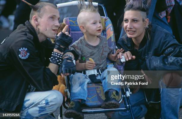Family wearing punk fashions in the audience at a Sex Pistols concert on the band's Flithy Lucre comeback tour, 1996.