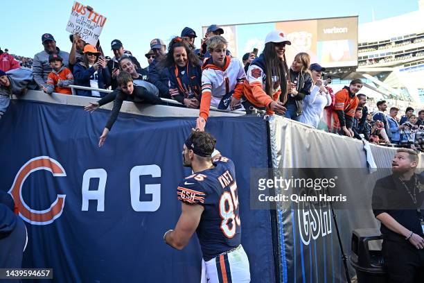 Cole Kmet of the Chicago Bears high fives fans after a loss to the Miami Dolphins at Soldier Field on November 06, 2022 in Chicago, Illinois.