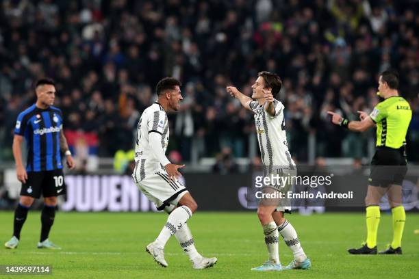 Danilo of Juventus celebrates their side's win with teammate Nicolo Fagioli after the final whistle of the Serie A match between Juventus and FC...