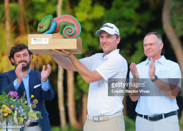 Russell Henley of United States holds the campion trophy during the ceremony after the final round of the World Wide Technology Championship at Club...
