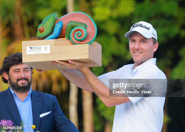 Russell Henley of United States holds the campion trophy during the ceremony after the final round of the World Wide Technology Championship at Club...