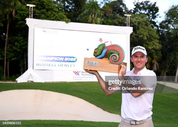 Russel Henley of United States poses with the championship trophy on the 18th hole after winning the final round of the World Wide Technology...