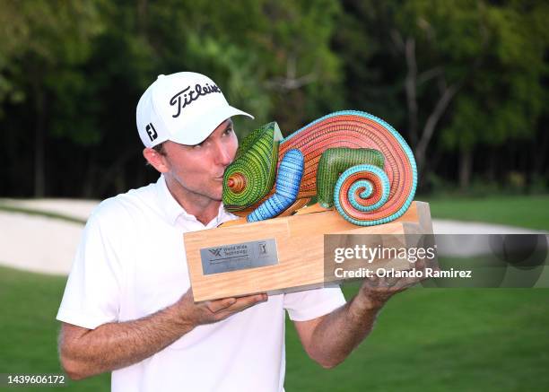 Russel Henley of United States poses with the championship trophy on the 18th hole after winning the final round of the World Wide Technology...