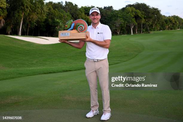 Russel Henley of United States poses with the championship trophy on the 18th hole after winning the final round of the World Wide Technology...