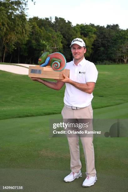 Russel Henley of United States poses with the championship trophy on the 18th hole after winning the final round of the World Wide Technology...