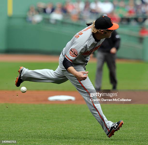 Mark Reynolds of the Baltimore Orioles fumbles a ground ball in the first inning against the Boston Red Sox at Fenway Park on May 6, 2012 in Boston,...