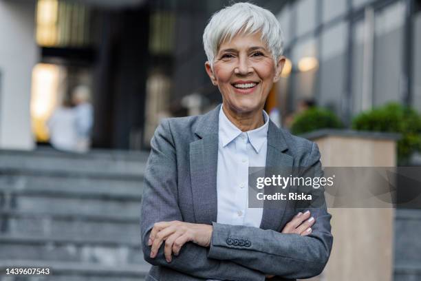 portrait of confident, happy mature woman - grey blazer stock pictures, royalty-free photos & images