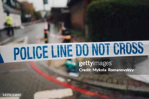 Police white and blue cordon tape separating the crime scene. Police white and blue cordon tape separating the crime scene.