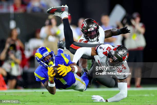 Allen Robinson II of the Los Angeles Rams makes a reception in the third quarter as Carlton Davis III and Lavonte David of the Tampa Bay Buccaneers...