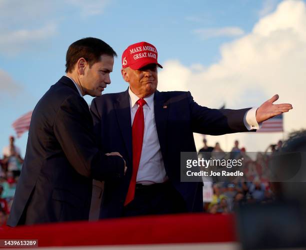 Former U.S. President Donald Trump invites Sen. Marco Rubio to speak at the microphone during a rally at the Miami-Dade County Fair and Exposition on...