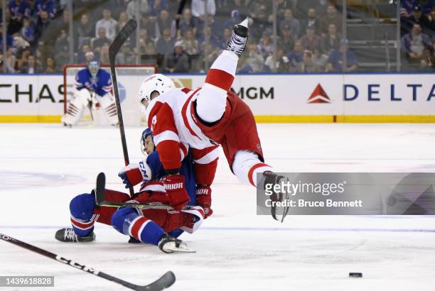 Zac Jones of the New York Rangers and Adam Erne of the Detroit Red Wings collide during the second period at Madison Square Garden on November 06,...