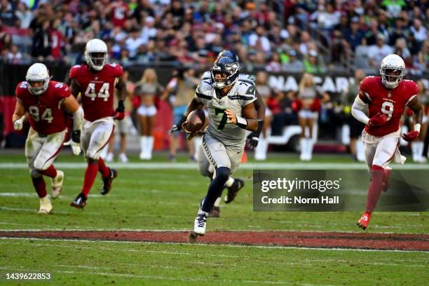 Geno Smith of the Seattle Seahawks runs with the ball during the fourth quarter of the game against the Arizona Cardinals at State Farm Stadium on...