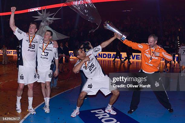 Thierry Omeyer and Daniel Narcisse of Kielcelebrate with the trophy after winning The Lufthansa Final 4 match between THW Kiel and SG Flensburg -...