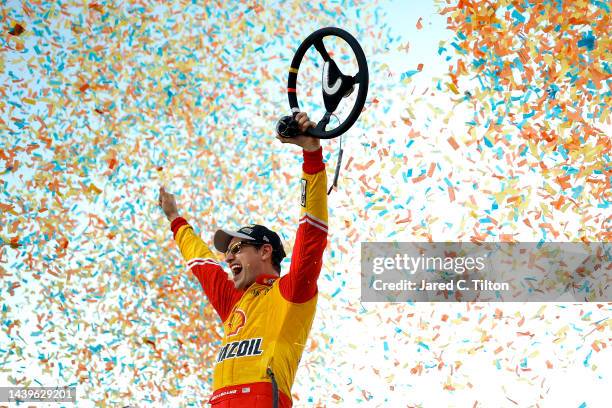 Joey Logano, driver of the Shell Pennzoil Ford, celebrates in victory lane after winning the 2022 NASCAR Cup Series Championship at Phoenix Raceway...