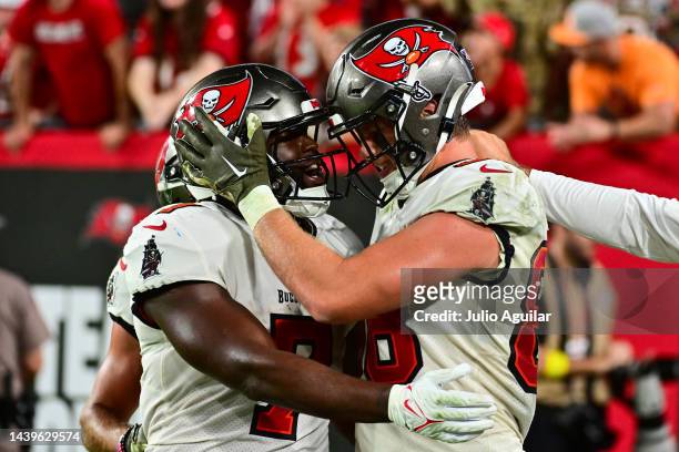 Cade Otton of the Tampa Bay Buccaneers celebrates his game winning touchdown against the Los Angeles Rams with Leonard Fournette of the Tampa Bay...