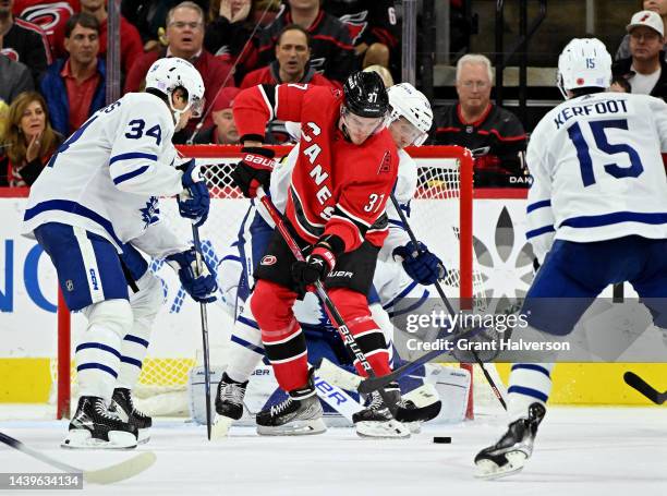 Morgan Rielly of the Toronto Maple Leafs defends Frederik Andersen of the Carolina Hurricanes in front of the net during the third period of their...